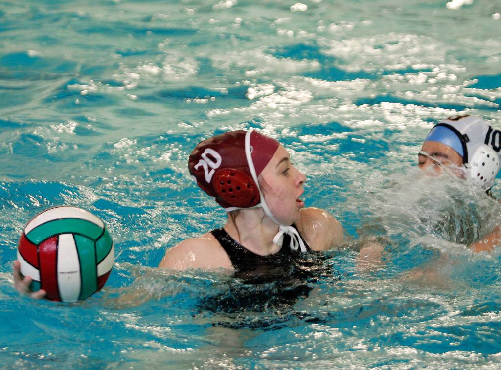 Jenna Hoisington tries to get some space to make a pass as Bainbridges Maja Carroll approaches. (Mark Krulish/Kitsap News Group)