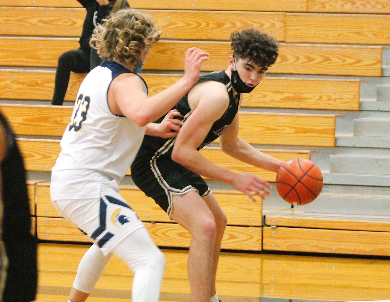 Jonas La Tour looks to get around Bainbridges Alan Ulin during Tuesday nights game at Bainbridge High School. La Tour had 24 points as North Kitsap won 62-54. (Mark Krulish/Kitsap News Group)