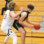 Jonas La Tour looks to get around Bainbridges Alan Ulin during Tuesday nights game at Bainbridge High School. La Tour had 24 points as North Kitsap won 62-54. (Mark Krulish/Kitsap News Group)