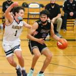 Johny Olmsted (0) is guarded closely by Bainbridge senior Jacob Kirsch (1). (Mark Krulish/Kitsap News Group)