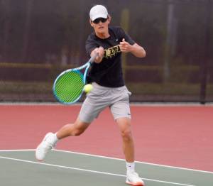North Kitsaps Josh Smith attacks the net for a point as he did many times throughout the championship match victory. (Mark Krulish/Kitsap News Group)