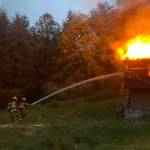 Firefighters Tony Reichmuth, left, and Corey Brown work to control the flames at the Kingston home.