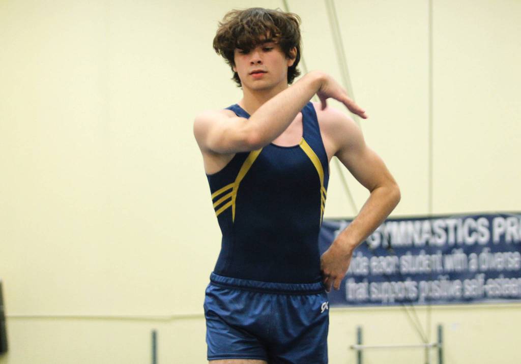 Aidan Cretarolo stands tall on the balance beam. (Mark Krulish/Kitsap News Group)