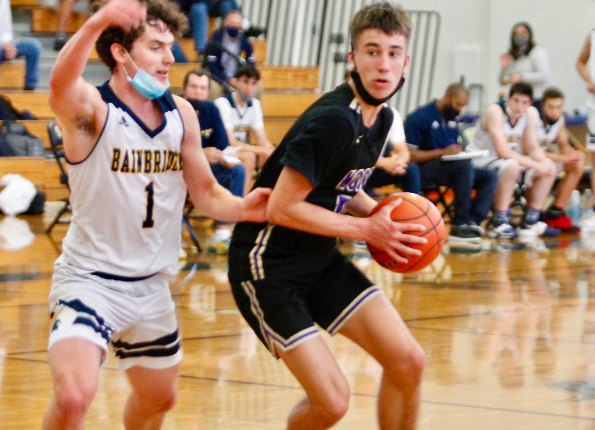 North Kitsaps Cade Orness looks to dribble past Bainbridge guard Jacob Kirsch. Orness tied Mondays semifinal match with a 3-pointer at the buzzer in regulation. The Vikings won in overtime. (Mark Krulish/Kitsap News Group)