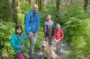 Foundation courtesy photos
Camilla, Elias, Micah, and Silas Gordon and dog Brewster turned out Saturday to mark National Trails Day with a walk on the new Blakely Hill Trails. The mile and a half of public trail easements north of Blakely Harbor were donated last summer through the Bainbridge Island Parks Foundation. The trails are seeing ongoing work by Bainbridge Metro Parks, with graveling, a footbridge and other enhancements for safe year-round use. Trailheads can be found along Old Mill Road (east of the cemetery road) and Blakely Hill Road, and a new path meets the Cemetery Trail halfway up from Blakely Harbor. Also, LinMara Bluebird, Joanie Klorer and Lisa Sheffer, below, sticky-dotted their favorite walking routes on a map showing BIs more than 42 miles of public trails.