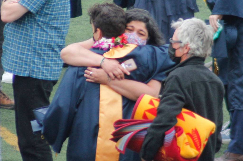 A graduate rejoices with loved ones after the ceremony. Tyler Shuey/Bainbridge Island Review
