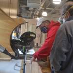 David Grant saws a piece of wood for the tiny house. Steve Powell/Bainbridge Island Review photos