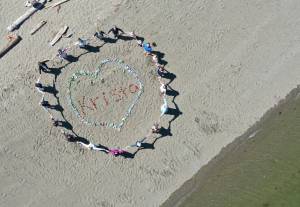 About 25 people gathered last Saturday on the beach at Pritchard Park on Bainbridge Island to remember Krista Murphy. Many were Realtors she worked with on the island. Participants spelled out her name, made a heart around it with flowers and then stood in a circle to say goodbye. Jeff Coupland/Courtesy Photo