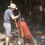 A group of church members digs up gravel into wheelbarrows.
Pouring of the gravel.