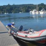 Haley Lamon of BI parks puts a boat out at a dock on Eagle Harbor.