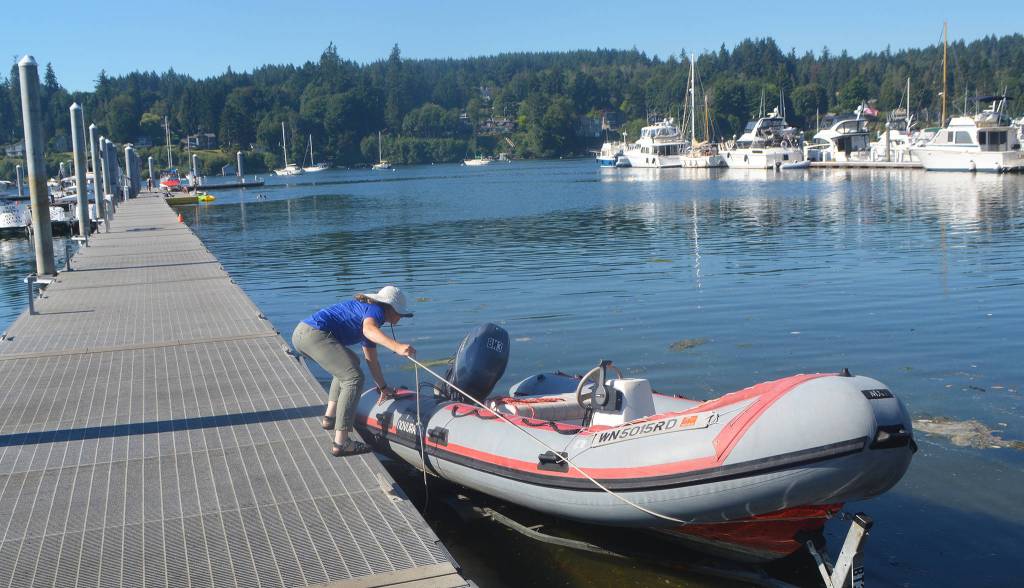 Haley Lamon of BI parks puts a boat out at a dock on Eagle Harbor.