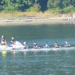 A rowing team was out on the waters of Eagle Harbor Monday with some early beachgoers in the background.