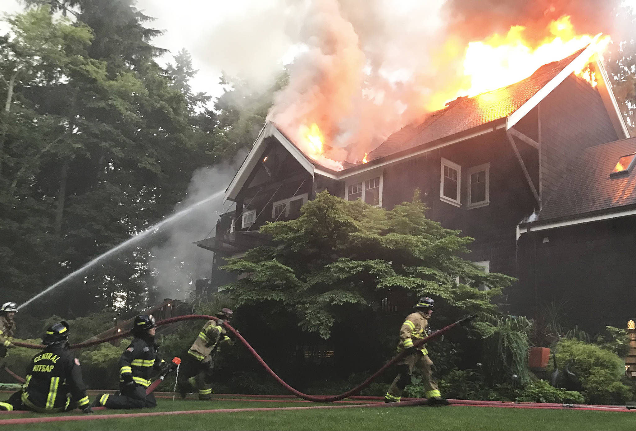 Firefighters work to put out the blaze at the house fire on Bainbridge Island Saturday. Bainbridge Island Fire Department Courtesy Photo