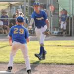 Ryan Rohrbacher flips the ball to Ely Olesen at first base after snagging an easy grounder. (Mark Krulish/Kitsap News Group)