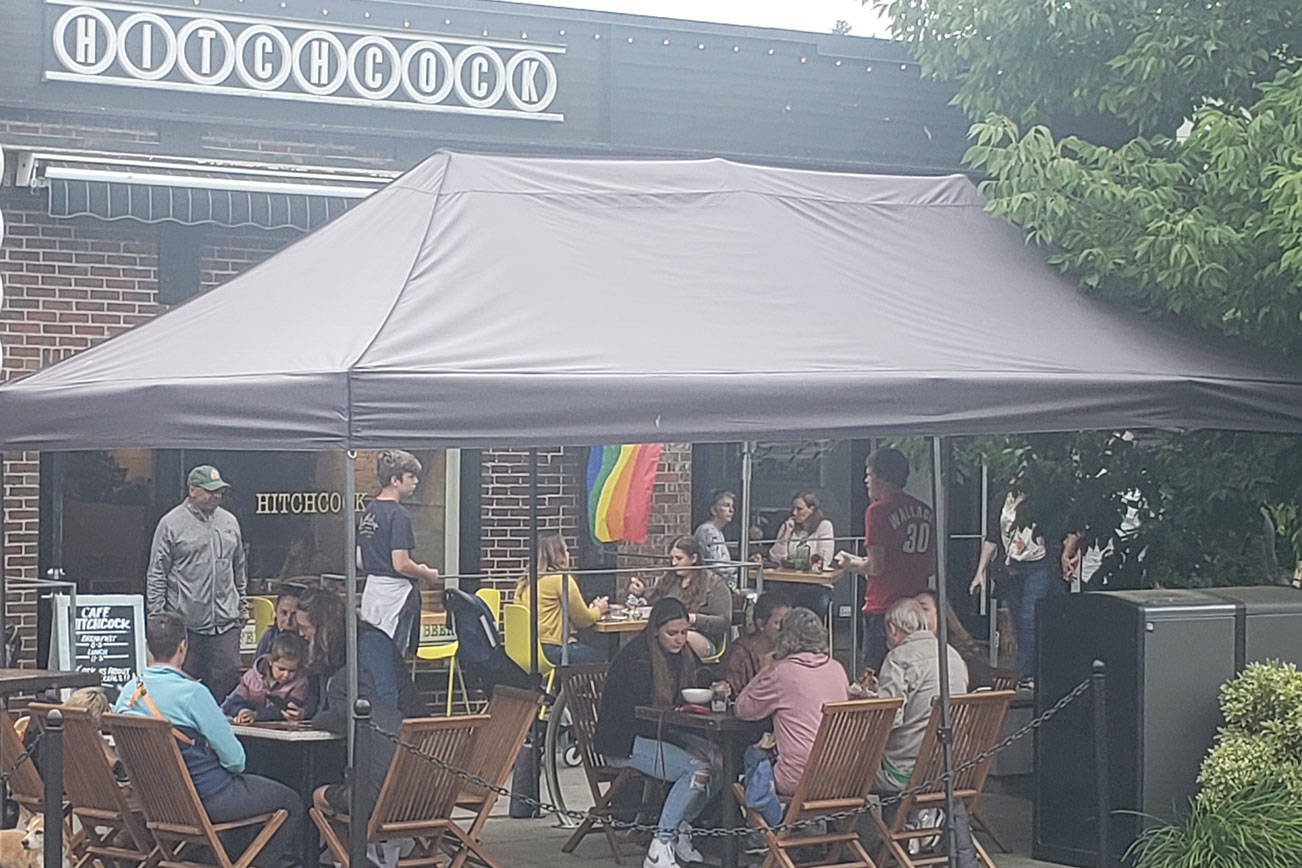 At Cafe Hitchcock, customers sit outside despite the overcast skies. Tyler Shuey/Bainbridge Island Review