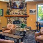 The lobby includes furniture and a big-screen TV.