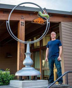 Artist Abe Singer stands next to his creation "Reflection" outside of City Hall. Courtesy photo