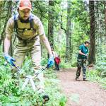 Will Gleason uses clippers to cut back vegetation near a trail. Courtesy Photos