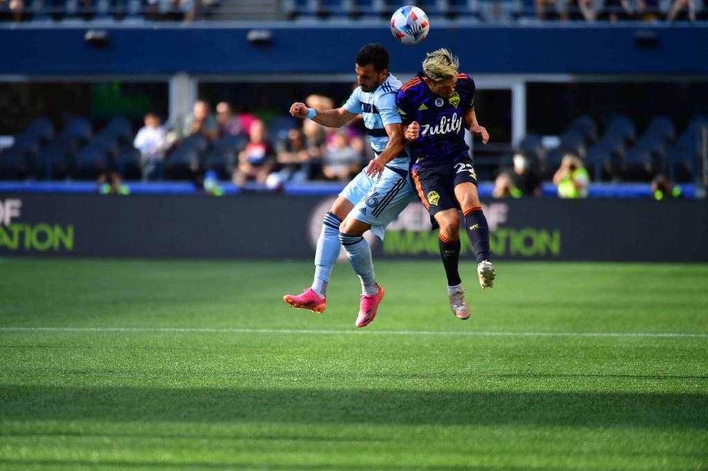 Kelyn Rowe, a native of Federal Way, gets the better of a Sporting KC player on a 50-50 ball. (Jane Gershovich/Sounders FC Communications)