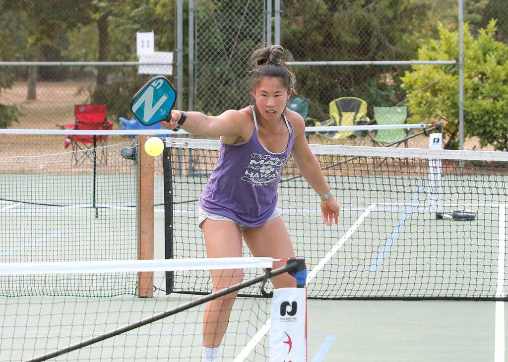 Janelle Chow of Redmond returns serve in the 3.0, 8-49 gold medal match, which she won with partner Josh Bond, also of Redmond. Chow also won a silver medal in a womens double tournament. (Mark Krulish/Kitsap News Group)