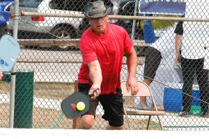 Don Sickle of Bainbridge Island makes a play at the net during a medal match in the Mixed Doubles tournament. Sickle and his partner, Kim Hemingway, won silver in the 3.0, 50+ group. (Mark Krulish/Kitsap News Group)