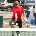 Don Sickle of Bainbridge Island makes a play at the net during a medal match in the Mixed Doubles tournament. Sickle and his partner, Kim Hemingway, won silver in the 3.0, 50+ group. (Mark Krulish/Kitsap News Group)