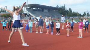 Steve Powell | Bainbridge Island Review
Above: Cheerleaders just start learning their routine for the halftime show. Right: Early on all of the campers got this part of the routine down.