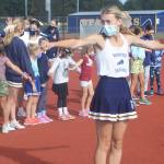 Bainbridge High School cheerleader Addy Ledbetter shows the youngsters the T formation.