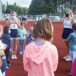 BHS cheerleader Claire Jackson, right of center, explains to the campers what they are going to do next.