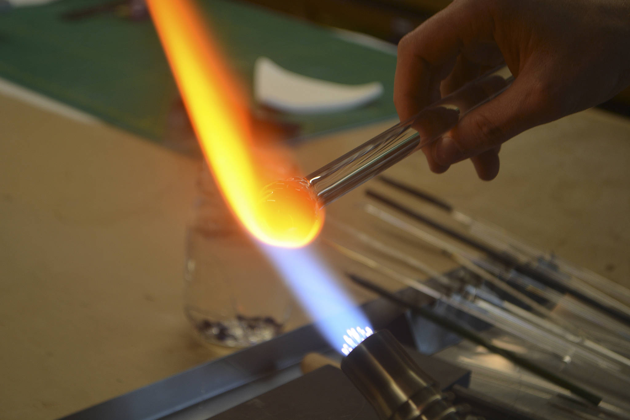 .
Grae Drake heats up materials in making a marble.
