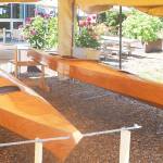 Mike Gearheard in the wood shop shows a few other kayaks that students are making.