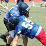 Strength up front: Wyatt Goade (59) and Axel Gibson go head-to-head in a drill during preseason practice. (Mark Krulish/Bainbridge Island Review)