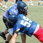 Strength up front: Wyatt Goade (59) and Axel Gibson go head-to-head in a drill during preseason practice. (Mark Krulish/Bainbridge Island Review)
