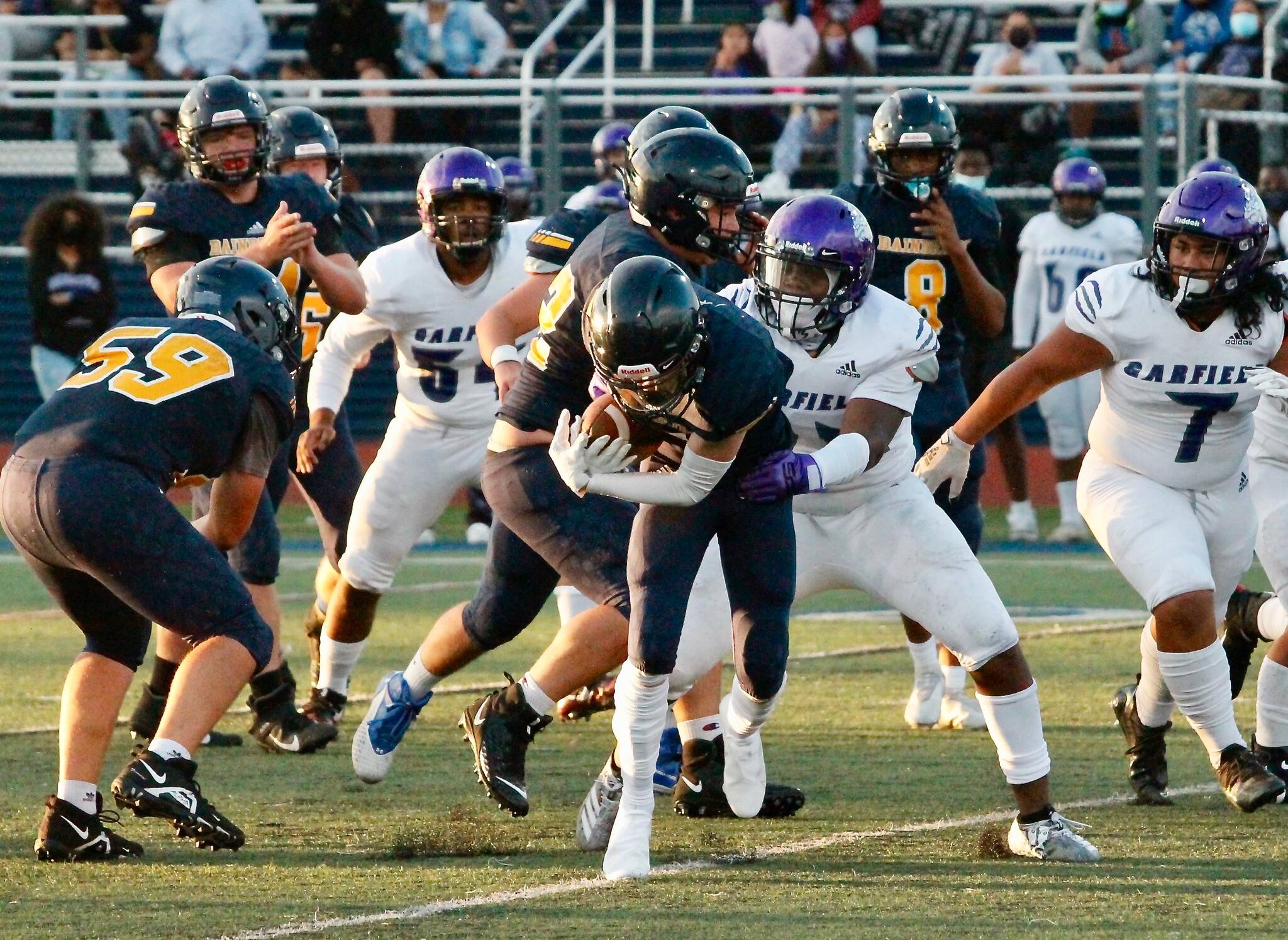 Bainbridge running back Matt LeDorze crashes through the line in the Spartans opening night game against Garfield. (Mark Krulish/Bainbridge Island Review)