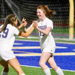Sky Henderson (29) rushes to congratulate teammate Avery Pujolar after scoring her third goal of the game in a 5-0 win over Bremerton. (Mark Krulish/Bainbridge Island Review photos)