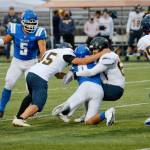 Bainbridges Jacob Dorsey (45) helps bring down Olympics Luke Silva (9) during Friday nights matchup. The Trojans prevailed 28-24. (Mark Krulish/Kitsap News Group)