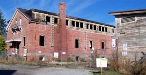 The stables, right, would be revitalized first, followed by the barracks, at left, later if the project at Fort Ward is approved. Courtesy Photo