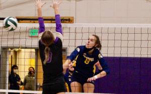 Allie Wildsmith of Bainbridge blasts a shot through the North Kitsap defense during her teams five-set win on Thursday night. (Mark Krulish/Kitsap News Group)