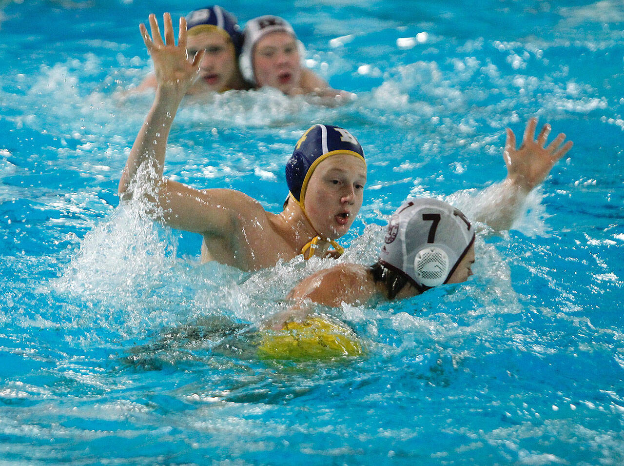 Finn Miller plays defense against his Mercer Island counterpart, Finn Friedland (7), in Monday nights water polo match agains the Islanders. Bainbridge won 17-8. (Mark Krulish/Kitsap News Group)