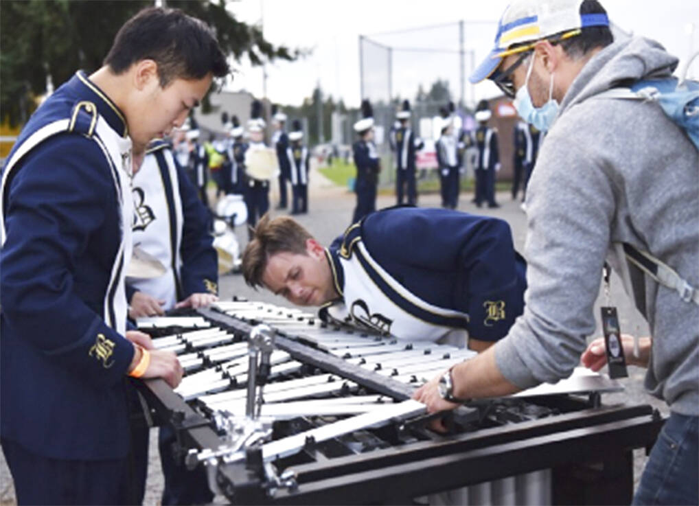 Director Chris Thomas, with help from percussion section, tries to fix the xylophone.
