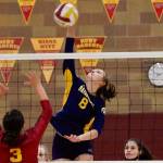 Bainbridge middle blocker Allie Wildsmith blasts a shot through Kingstons defense in her teams three-set win Tuesday night. (Mark Krulish/Kitsap News Group)
