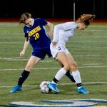 Bainbridge senior Maddy Brown looks to pry the ball loose from a Sequim player during her teams 1-0 win Thursday night. Mark Krulish/Bainbridge Island Review photos