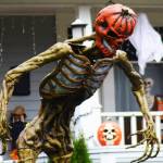 Trick-or-treaters are going to have to muster up some bravery to try to get away with any treats from this house with this scary, giant, pumpkin-headed skeleton providing protecting.