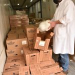 Town & Country meat department manager Tony Lane unboxes a frozen turkey in the "turkey truck" where some of the 1,071 whole turkeys and 324 turkey breasts were stored for Thanksgiving shoppers.