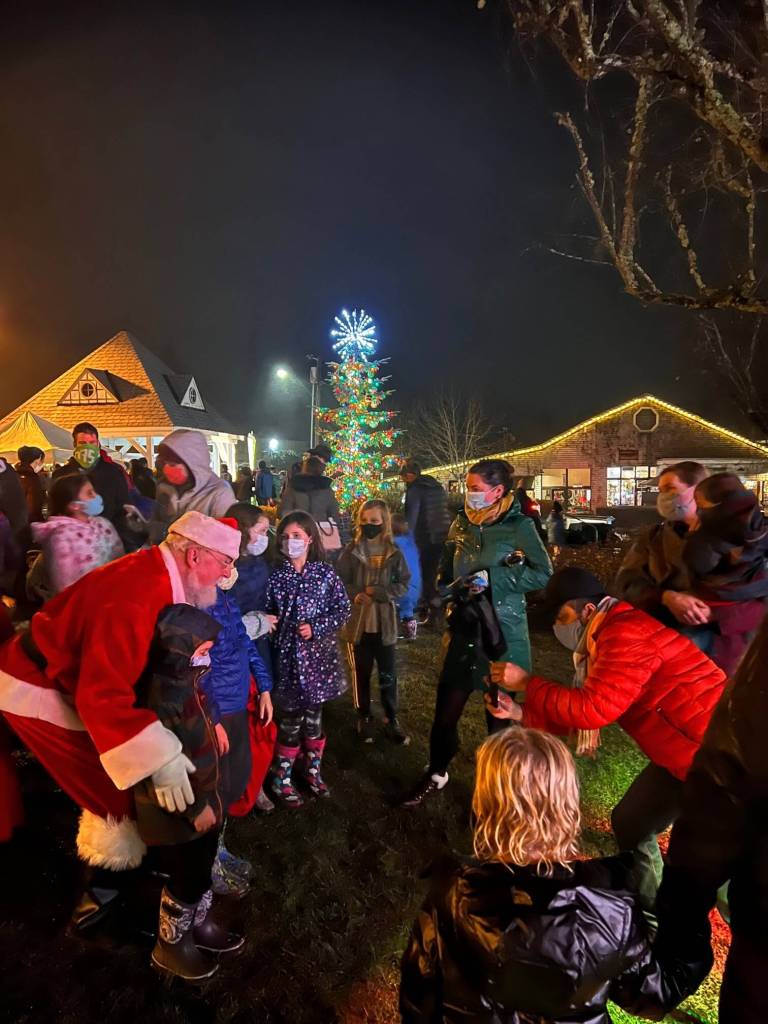 Santa poses with children after the Annual Tree Lighting held at Winslow Green.
