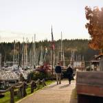 A couple walks along the boardwalk at the Winslow marina.
