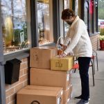 Berry Patch owner Jane Pomeroy unboxes items for her kitchen store that has been in business for 51 years.