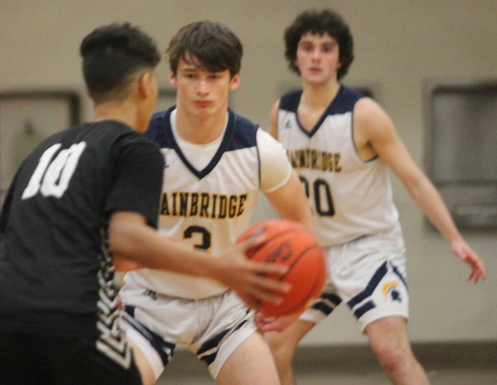 Cliff Hennessey (3) and Henry Cartsen (20) play defense in the Central Kitsap game.