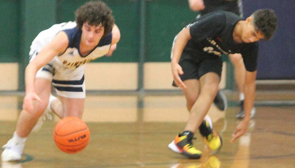 Spartan Henry Carsten (20) comes up with a steal against the Cougars.