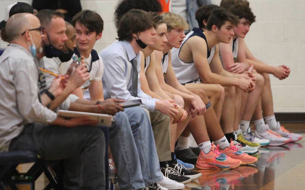 BI coaches and bench players watch the action against Central Kitsap.
